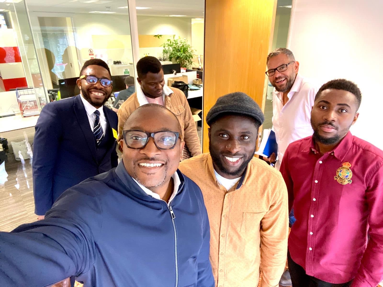 Five members captured mid-laugh after a workplace wellbeing visit.